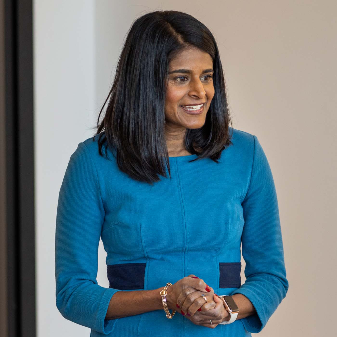 A woman in conversation with coworkers next to her and out of frame in the Pivotal Ventures office.