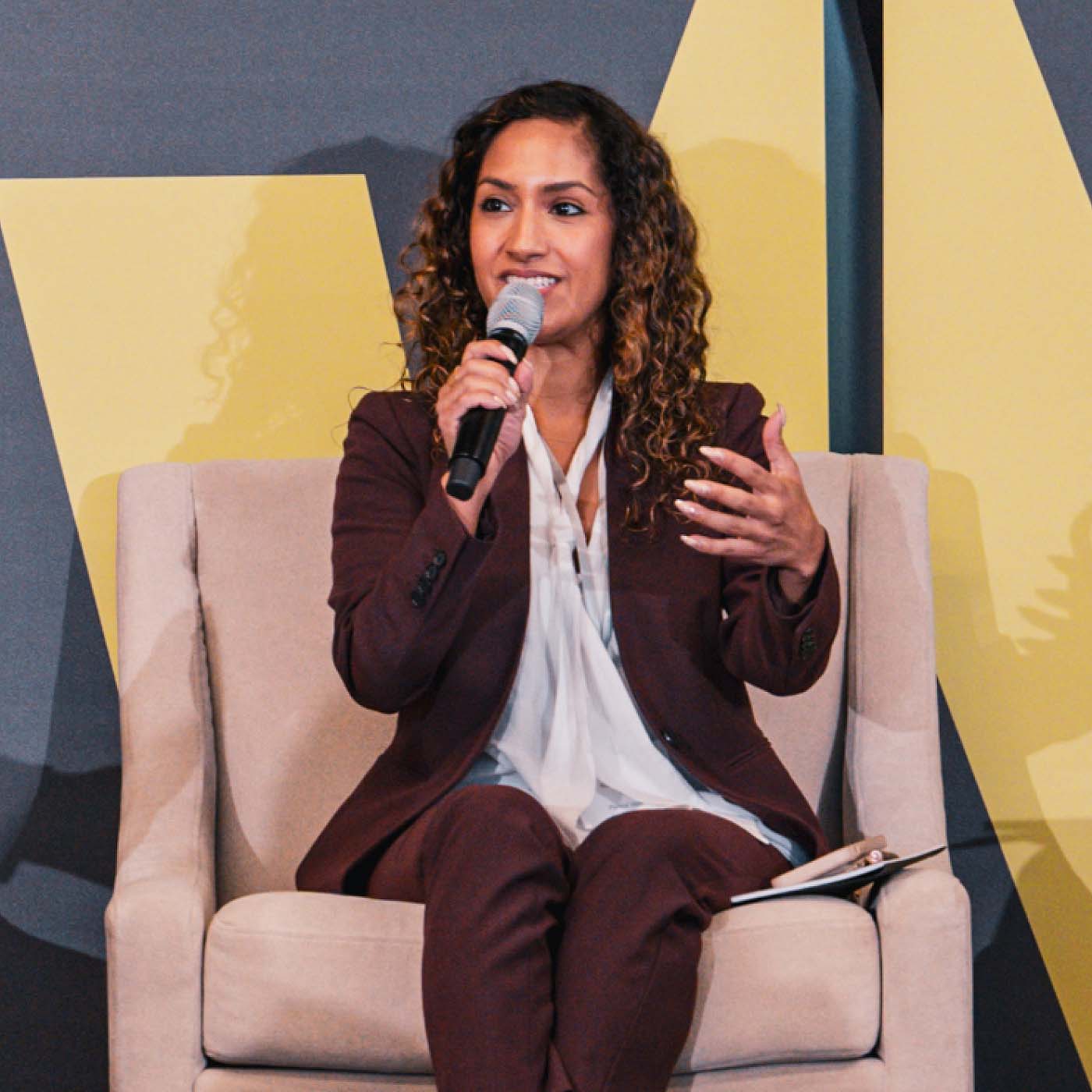 A woman speaking to an audience at the Growth Warrior Capital Summit in 2023.