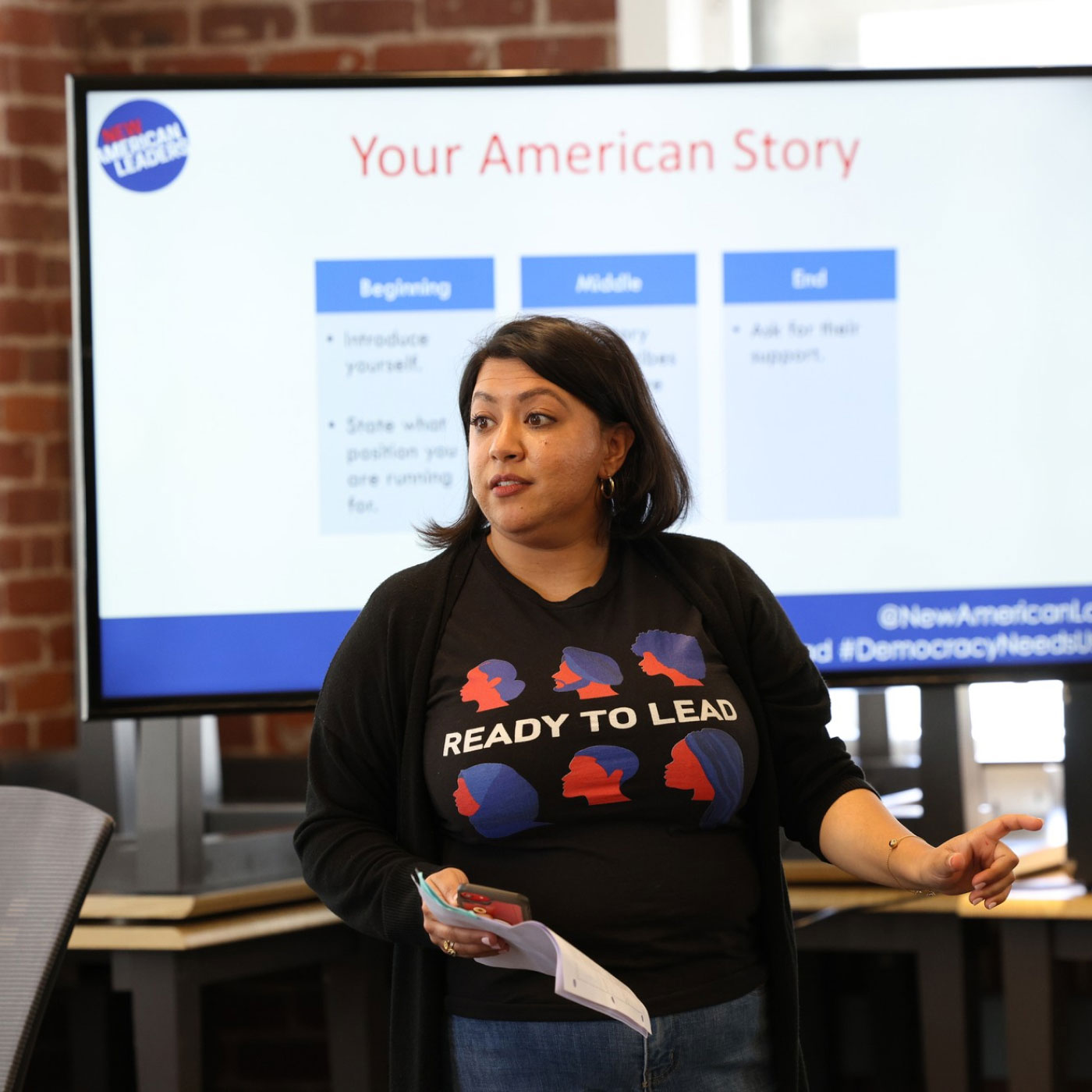 A woman speaking to an audience during a training program for civic leadership.