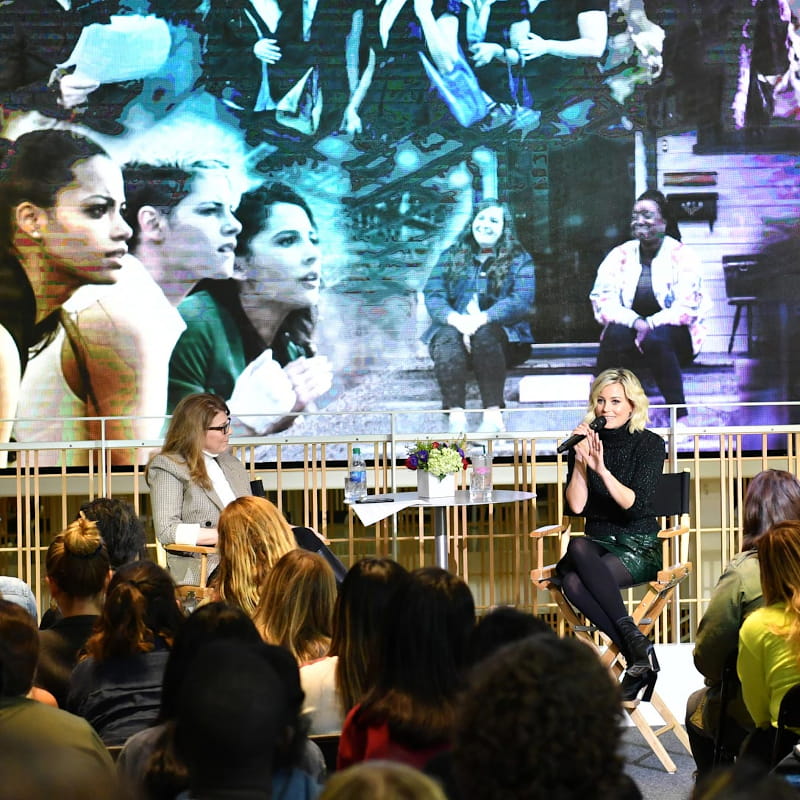 Dr. Stacy Smith and Elizabeth Banks sit on a stage to speak at a Q&A.