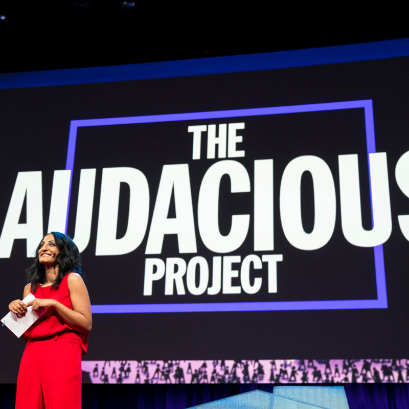 Anna Verghese, Executive Director of The Audacious Project, introducing the initiative on stage at a TED event.