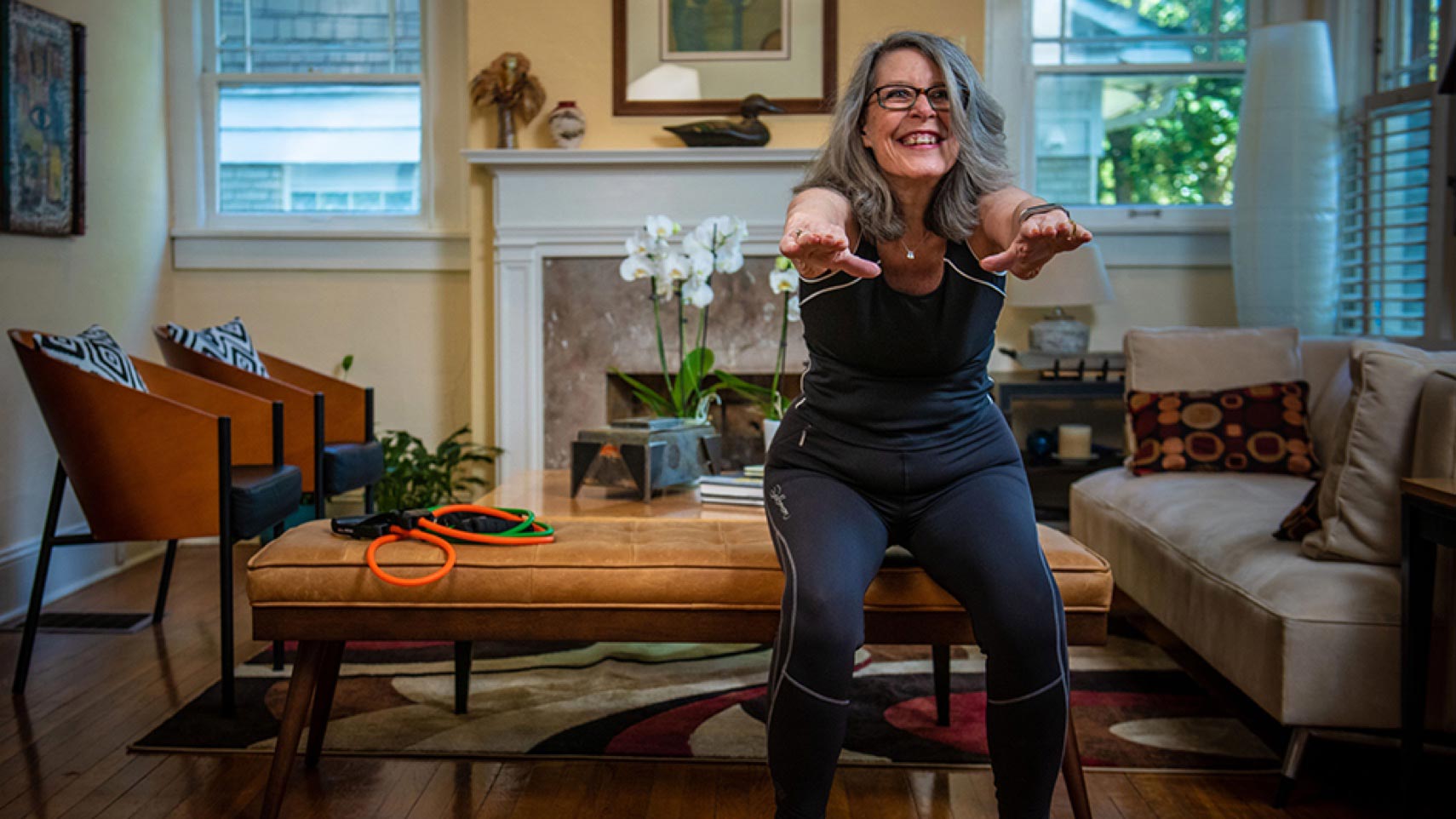A person smiles while doing a squat.