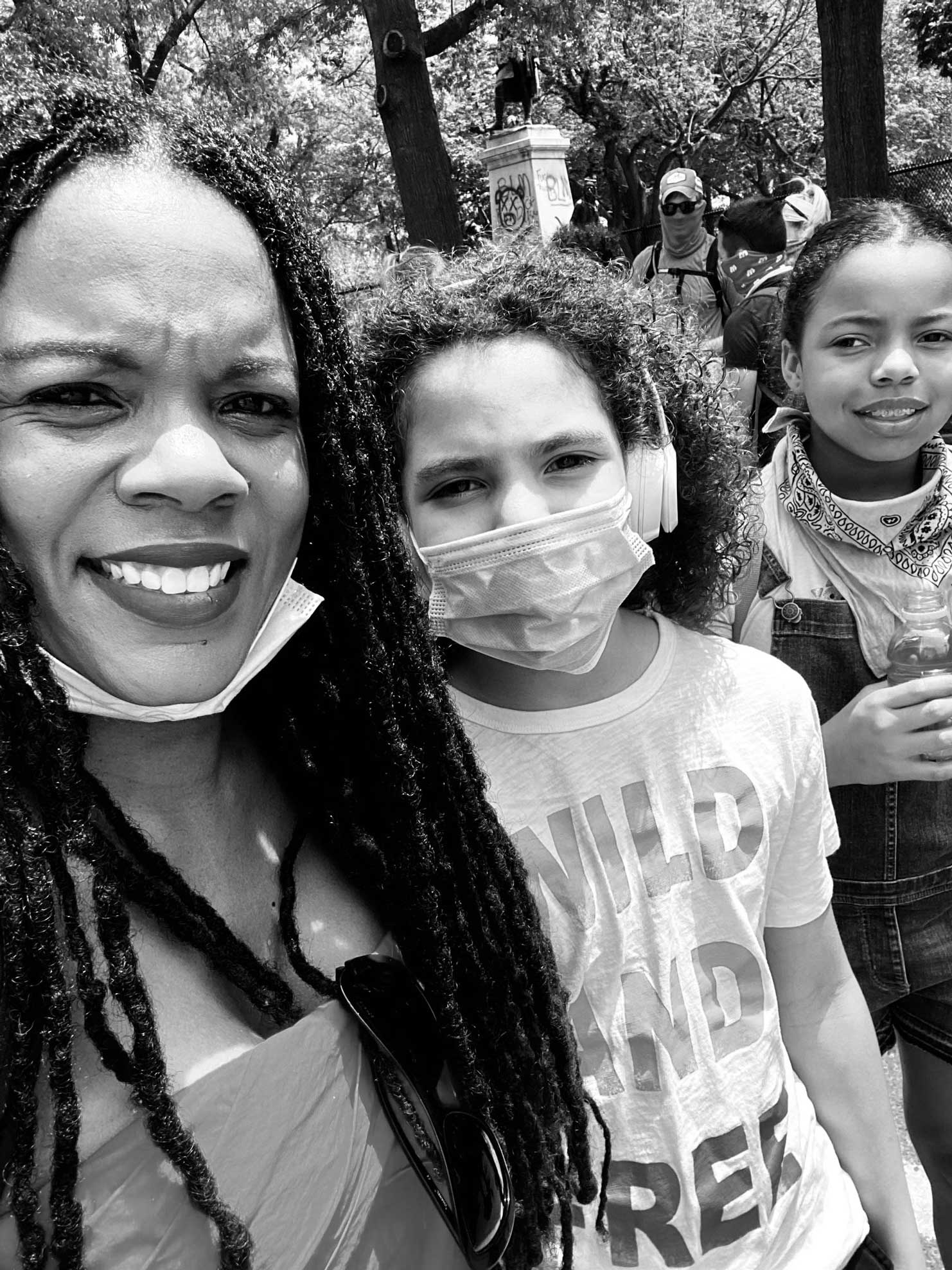 Dr. C. Nicole Mason poses for a selfie with her two children, the three of them wearing protective masks during the COVID-19 pandemic