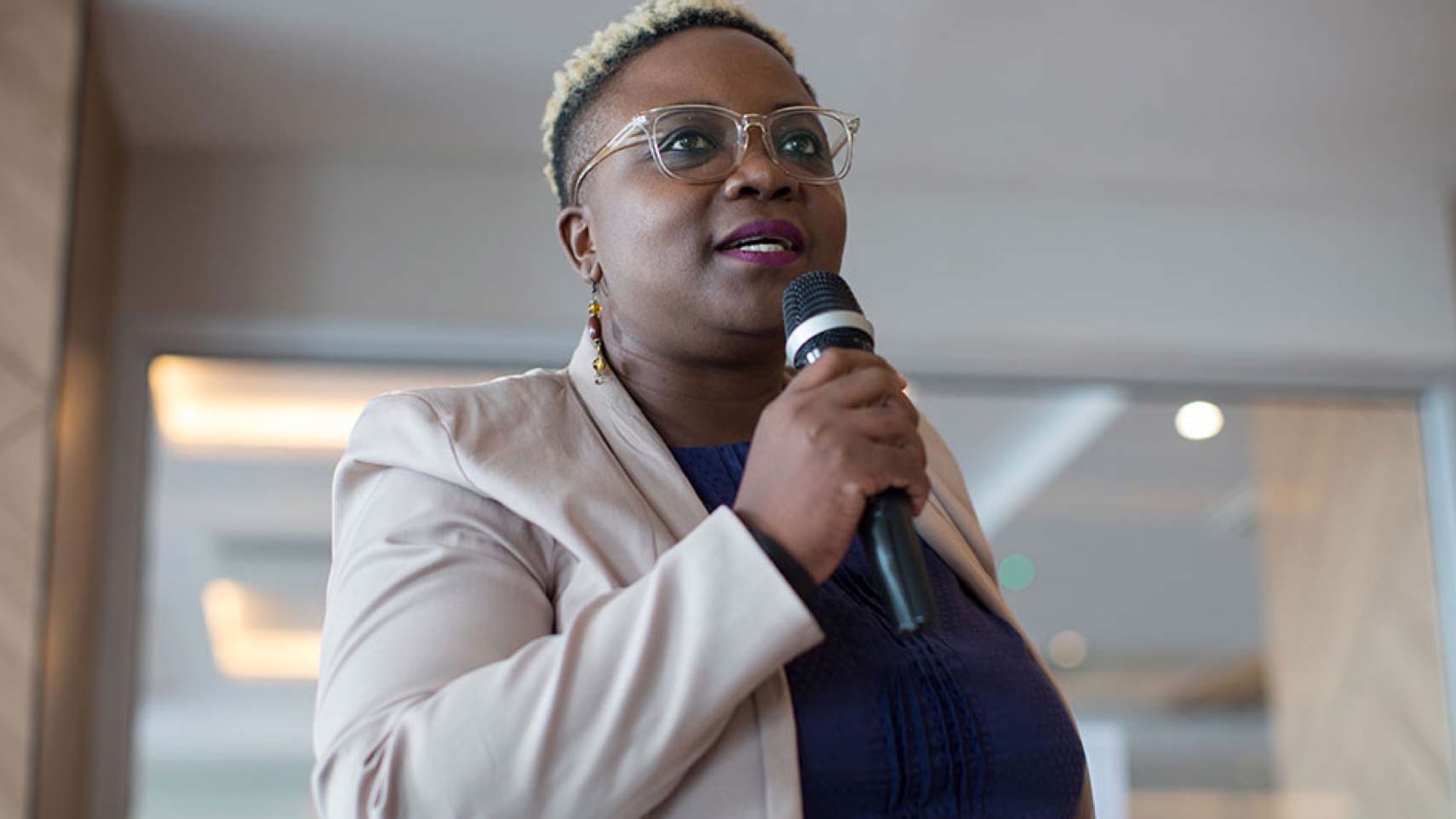 A person speaks into a microphone.