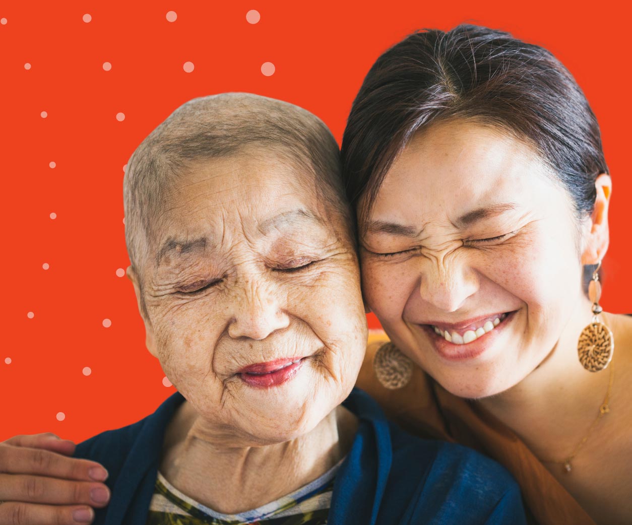 A woman with a scrunched smile gives a side hug to her mother.