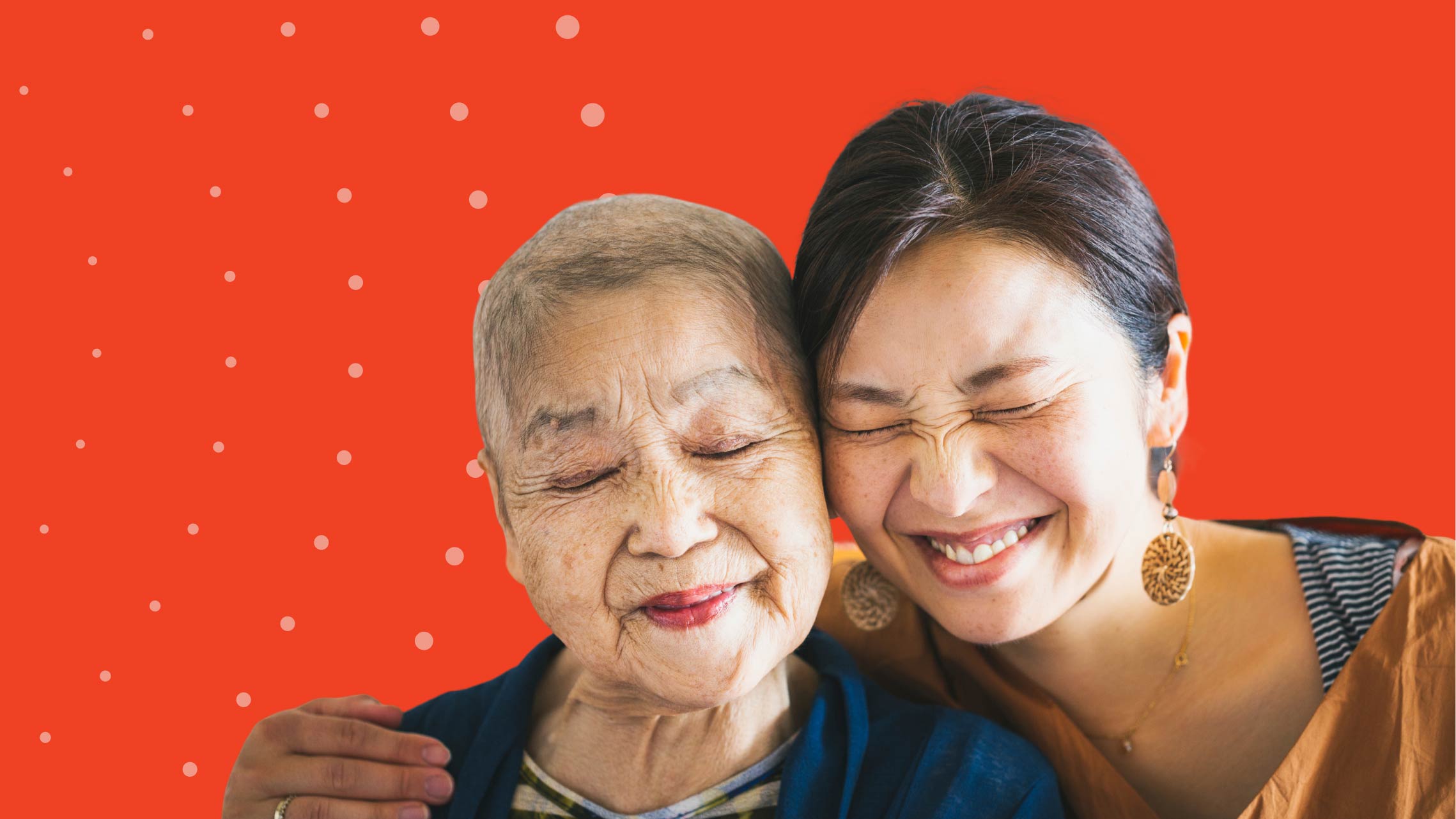 A woman with a scrunched smile gives a side hug to her mother.