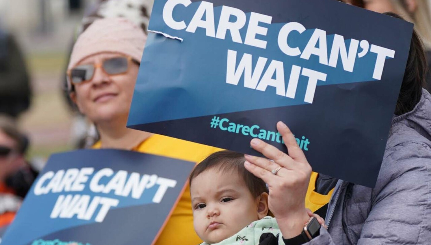 Women protesting with signs advocating for better care systems