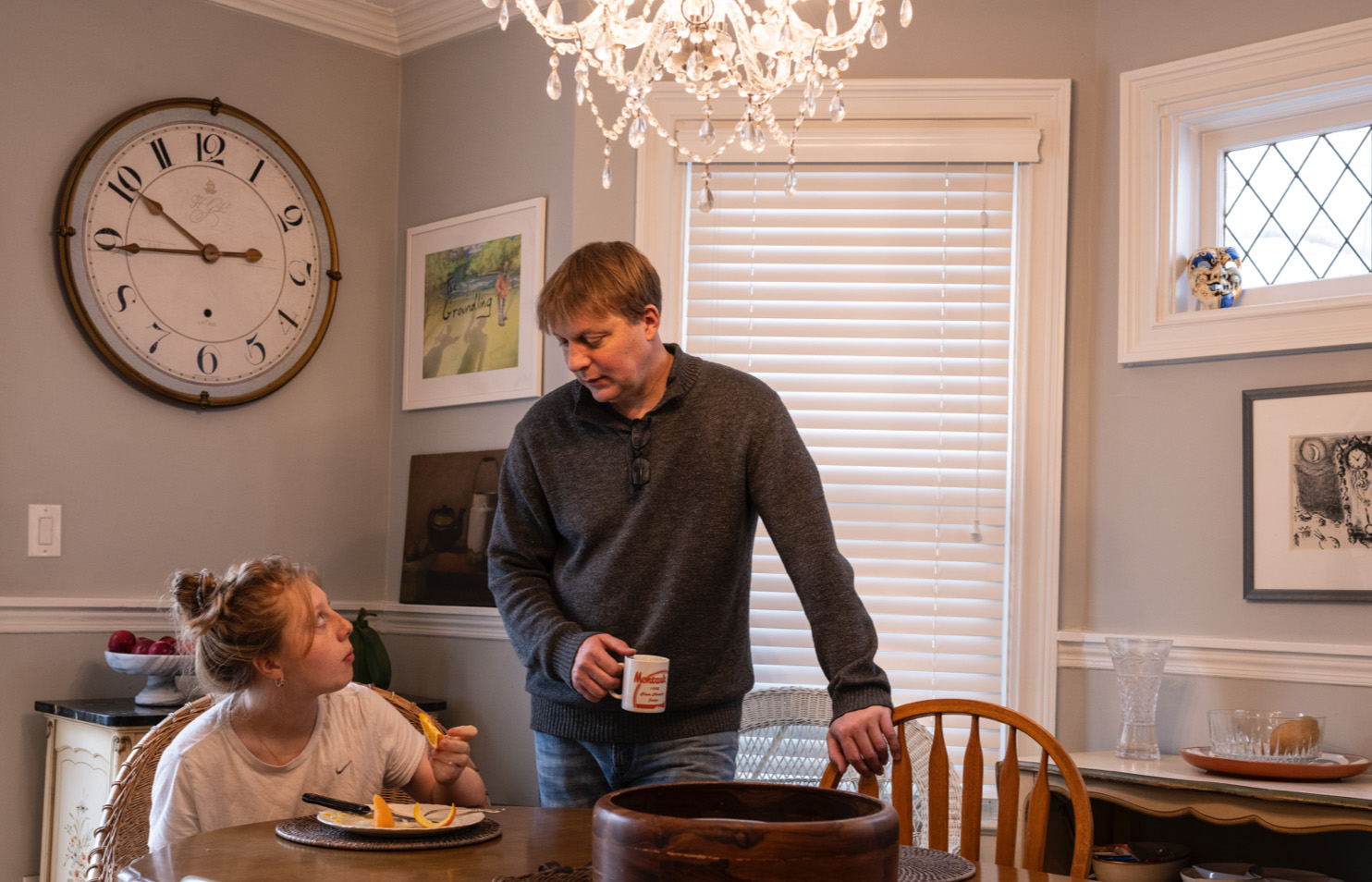 Students gather around a laptop computer.