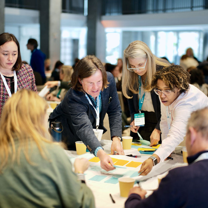 A group of Forward Global members working together at a recent summit.