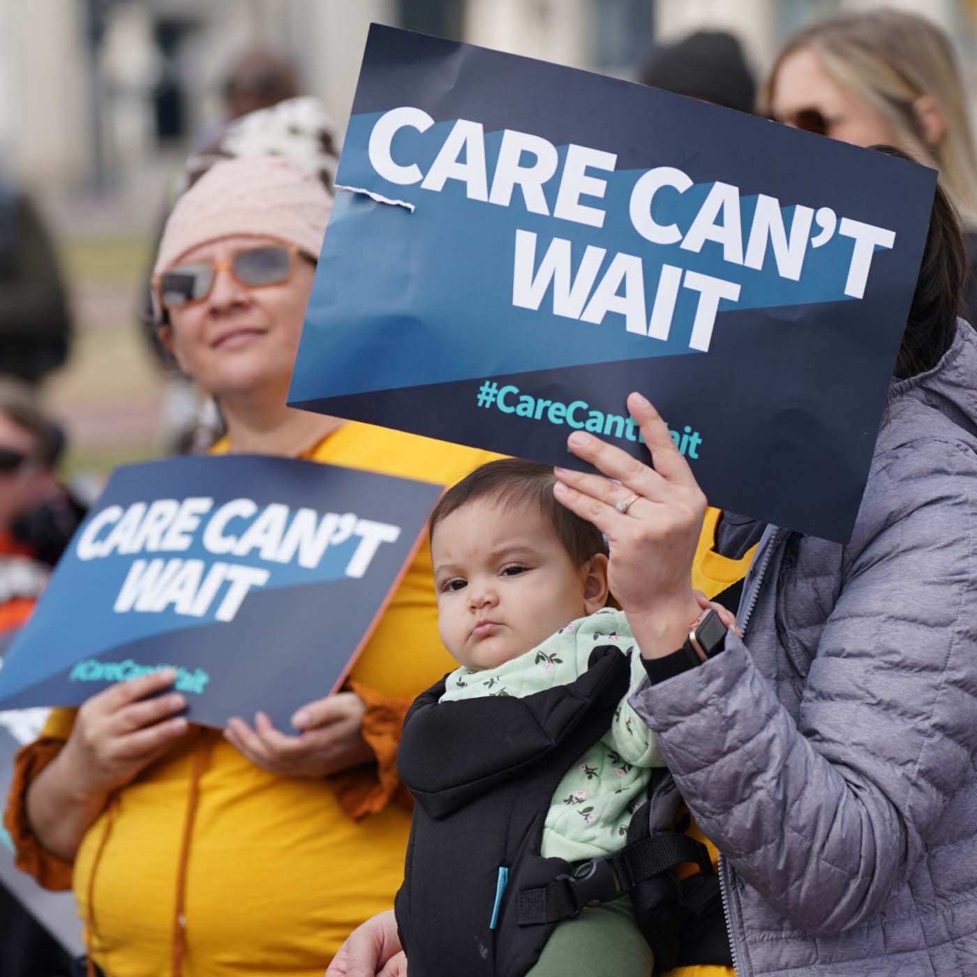 Women protesting with signs advocating for better care systems