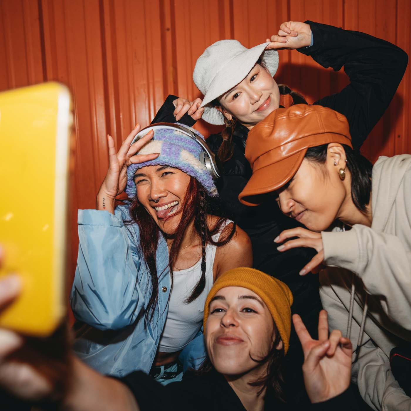 Four young adult women posing to take a selfie together
