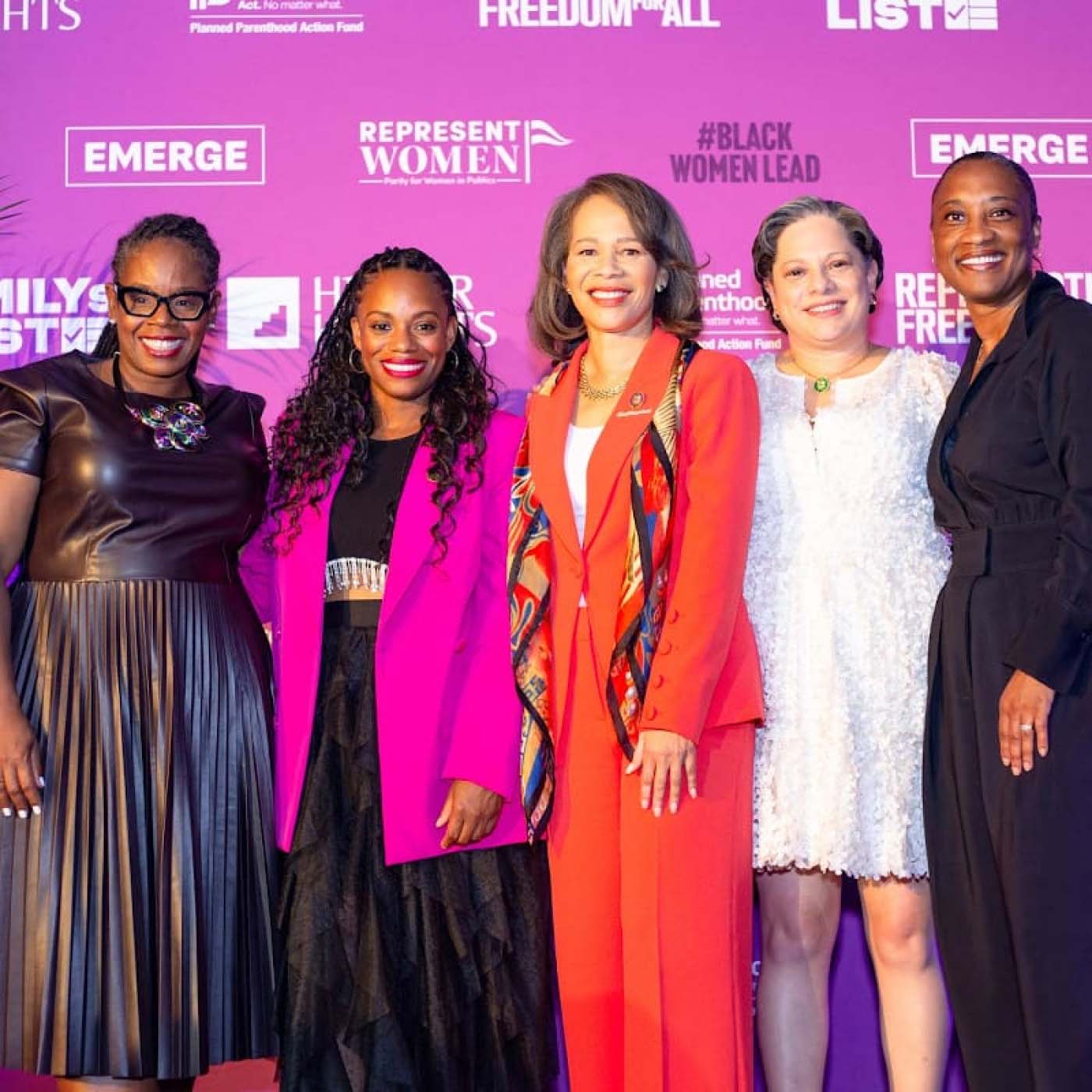 Five women posing for a photo at an event supporting Black and female representation in politics
